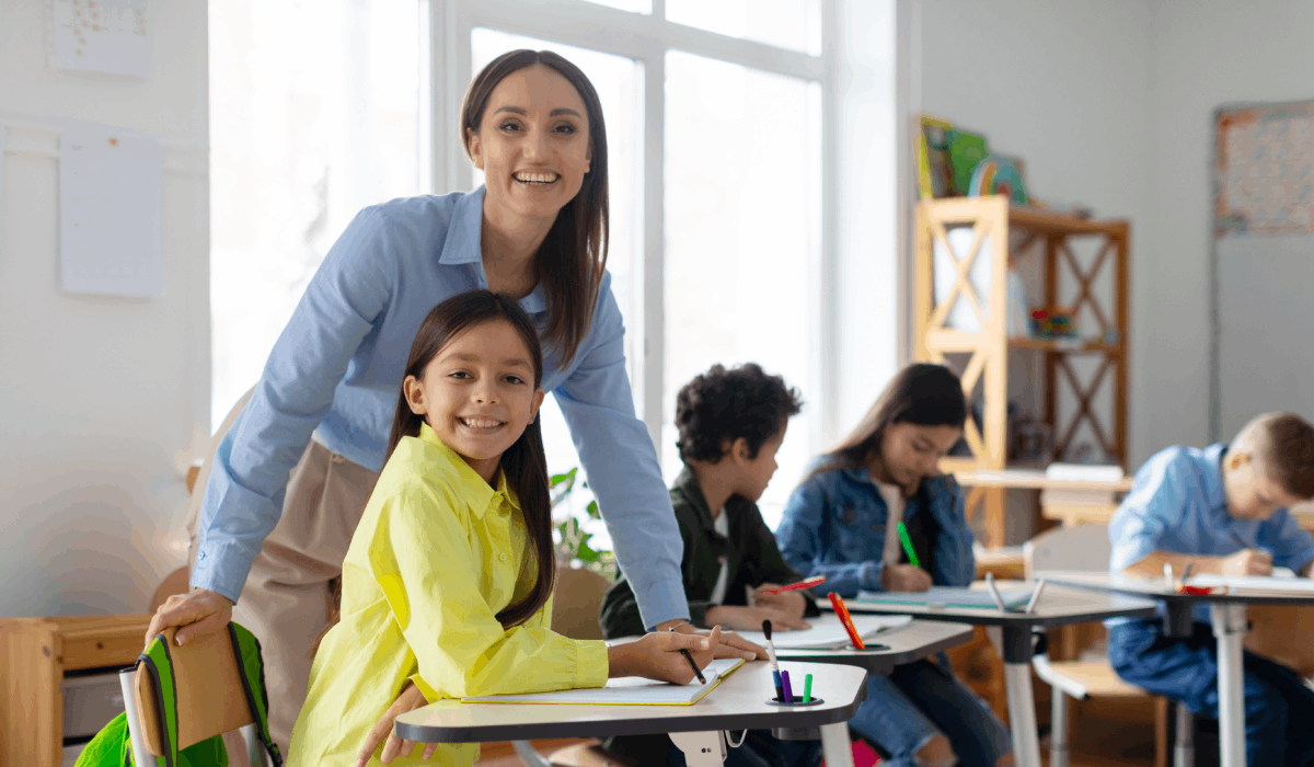 Primary school teacher leading safeguarding discussion with staff to improve school safeguarding practices